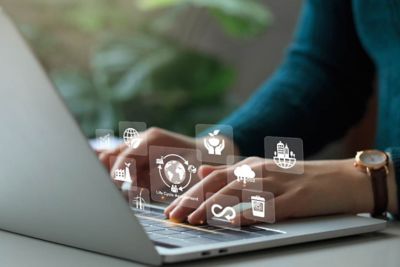 hands laptop with digital icons, Full life cycle management, Business process services: Life and wealth | DXC Technology