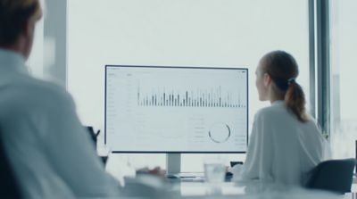 Employee using computter representing Hogan Health Check service, Hogan Core Banking Platform | DXC Technology Platforms