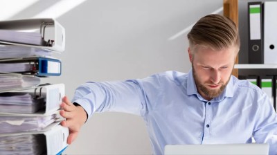 Man moving folders - It's time to automate the ceded reinsurance process | DXC Technology Insights