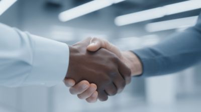 Insurance executives walking in brightly-lit office building, Life & Annuity insurance solutions | DXC Technology 