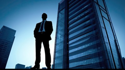 business person fiction standing in front of building
