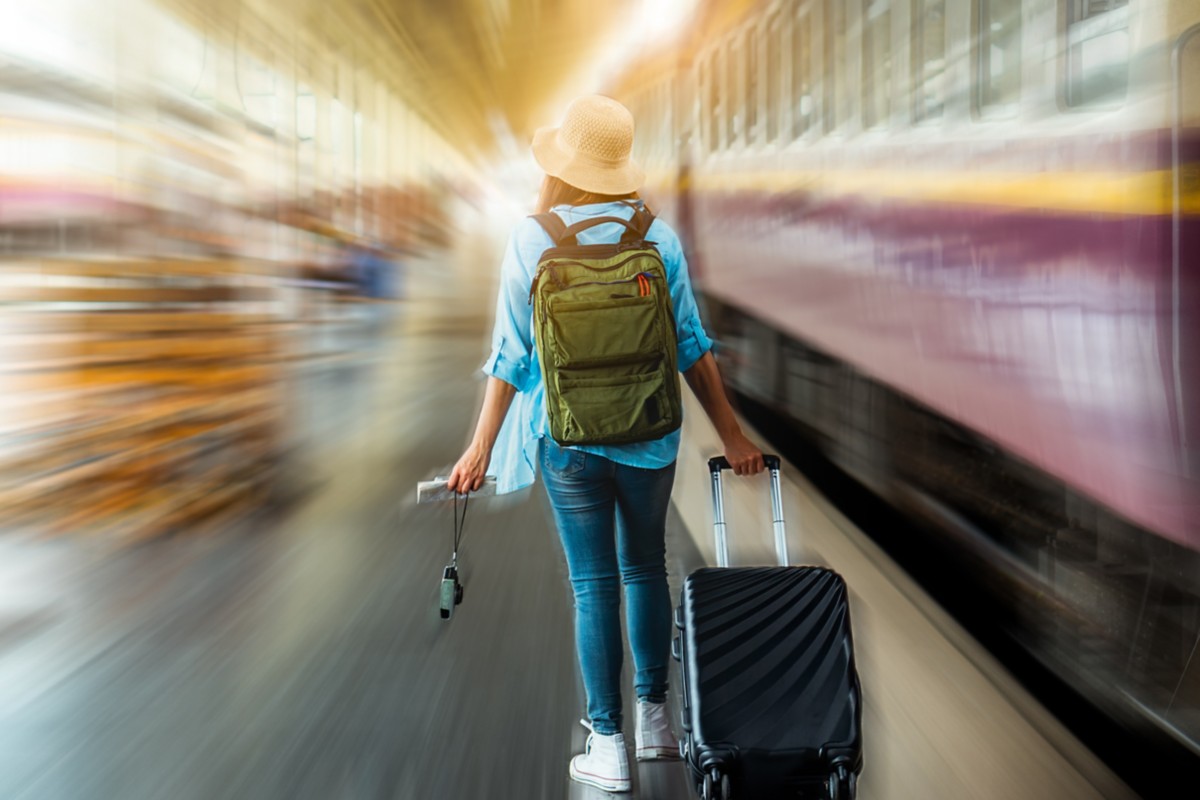 Background empty platform no tourist with solo young woman backpacker tourist step off tain ready for freedom explore in summer holiday after coronavirus crisis quarantine. Plan safe adventure trip.