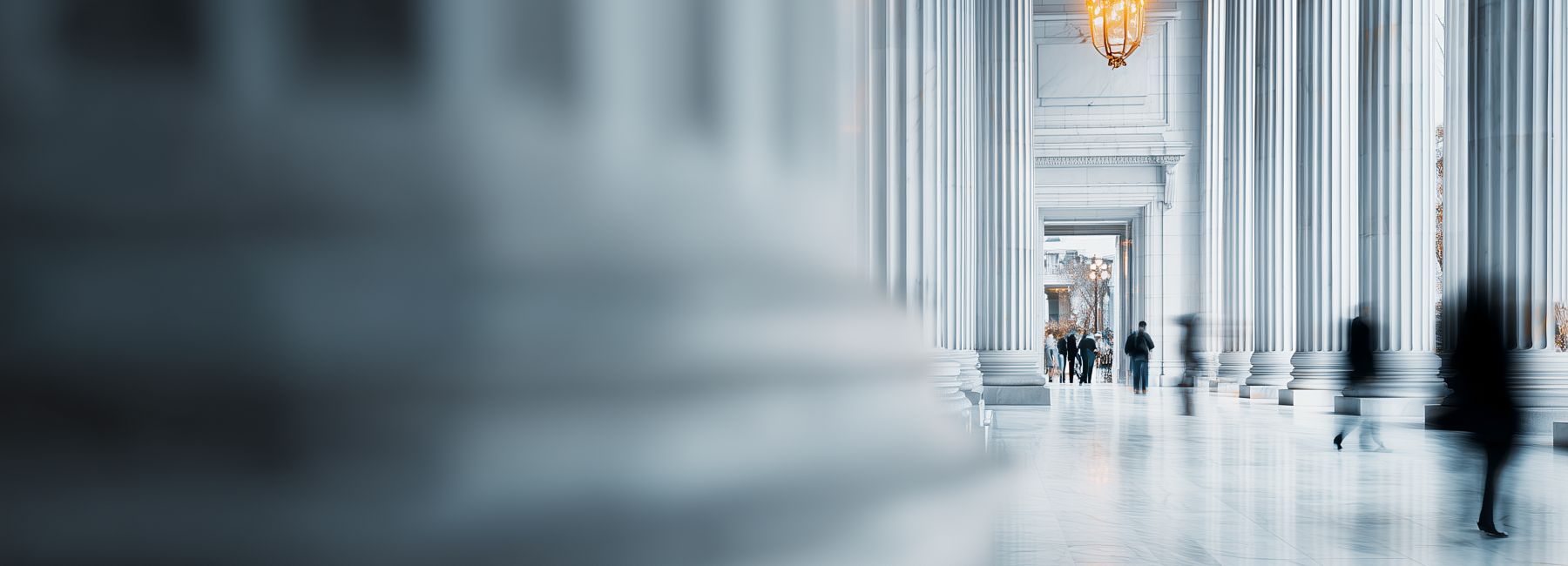 Government workers walking through marble-floored public building, Agentic Government Transformation | DXC Technology 
