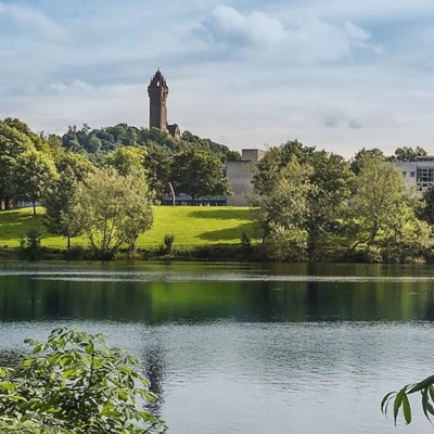A view of the Scottish countryside with trees and lake - AI agents power the public sector | DXC Technology Insights