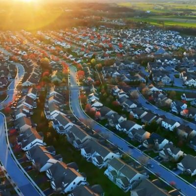 Aerial view of residential neighborhood at dusk, Corvias Video | DXC Technology Customer Story