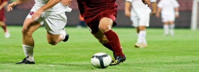 Two soccer player on the field with ball