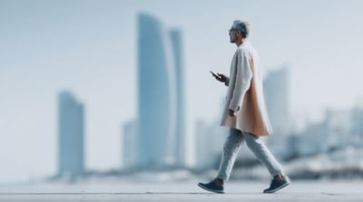 Man walking down the street, Software solutions defining the future of automotive | DXC Technology