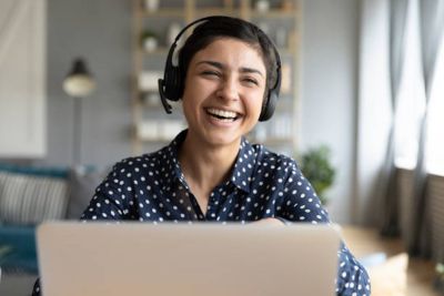 Cheerful indian woman wears headset