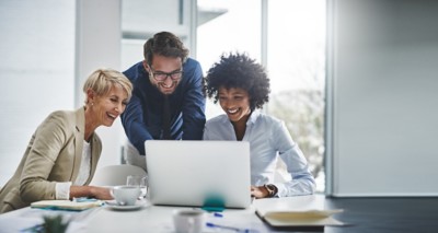 Laptop, collaboration and business people in the office while working on a company project. Technology, teamwork and team doing corporate research in discussion together with technology in workplace.