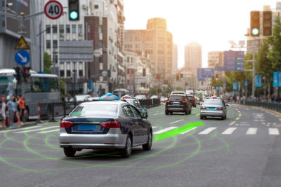 cars on city street that has green sensor arrow overlay