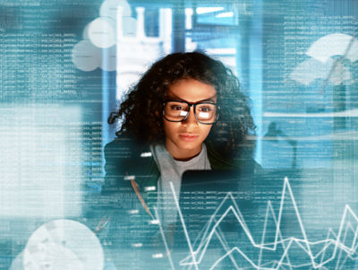 black female in front of computer with data graphic overlay