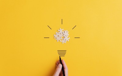 Light bulb over yellow background in vision and idea conceptual image