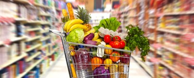 Full shopping grocery cart in supermarket.