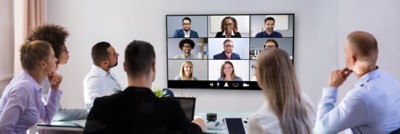 Group Of Skillful Businesspeople Video Conferencing In Boardroom