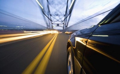 Car Speeding along Busy Bridge