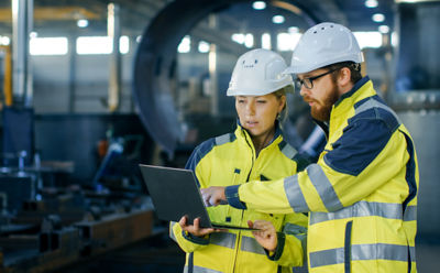 Engineers looking at a tablet